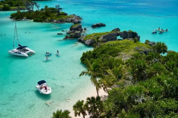 Aerial of a beach with two boats in the water