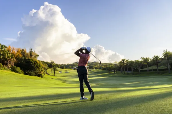 A man teeing off on a golf course in Bermuda