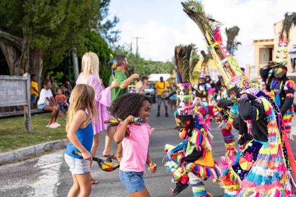 A little girl dancing with Gombey dancers in Bermuda