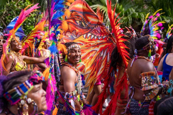 A smiling man in a feathery costume at Carnival in Bermuda