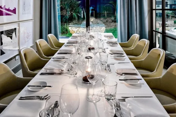 A long banquet table with a white table cloth