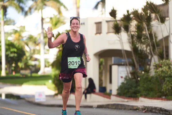 A woman running on the street during the Chubb Bermuda Triangle Race