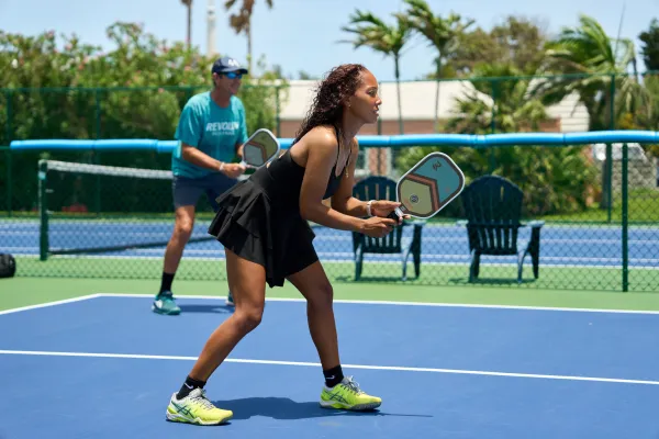 A pair of pickleball players prepare to receive a serve in Bermuda