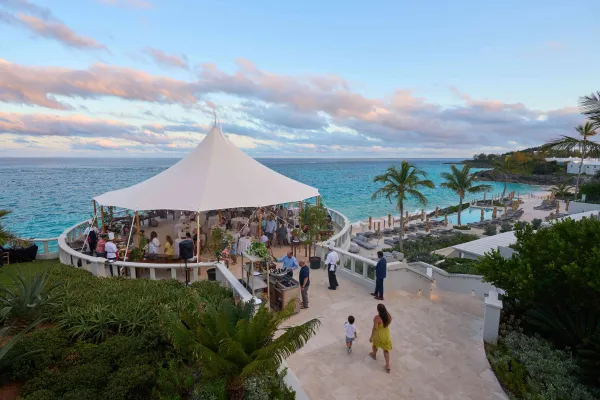 A group of people gathering in a gazebo overlooking the ocean in Bermuda