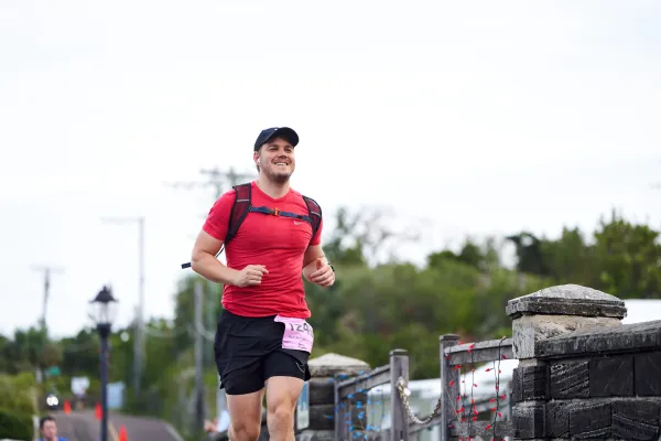 A smiling man running in the PWC half marathon in Bermuda