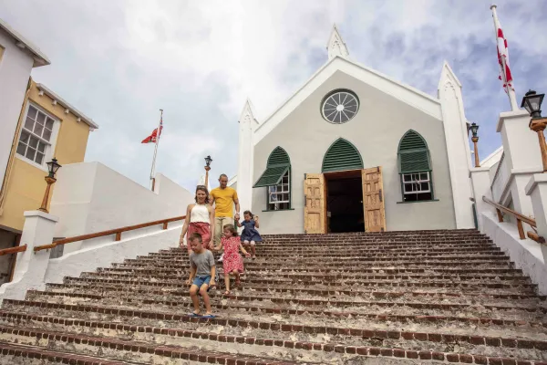 A family descends the steps of a historic church in Bermuda