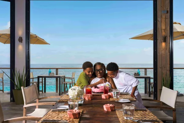 A family snuggling and celebrating a birthday in a private dining room