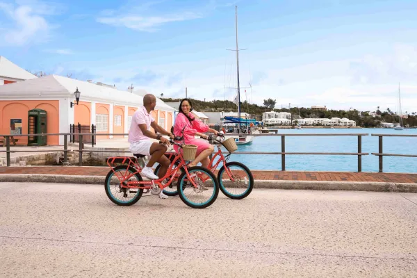 A couple is riding bicycles down St. George's.