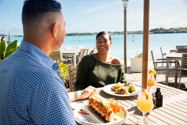 A couple are sitting outside in the winter sun