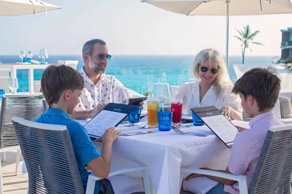 A family is eating dinner outside.