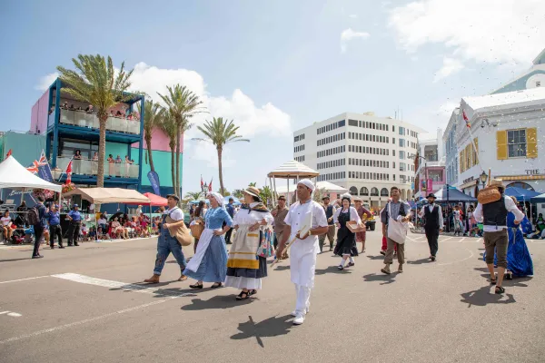 A group of people are walking in the Bermuda Day parade.