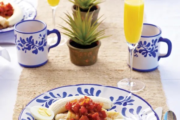 A traditional codfish breakfast with mimosas and colourful plate.