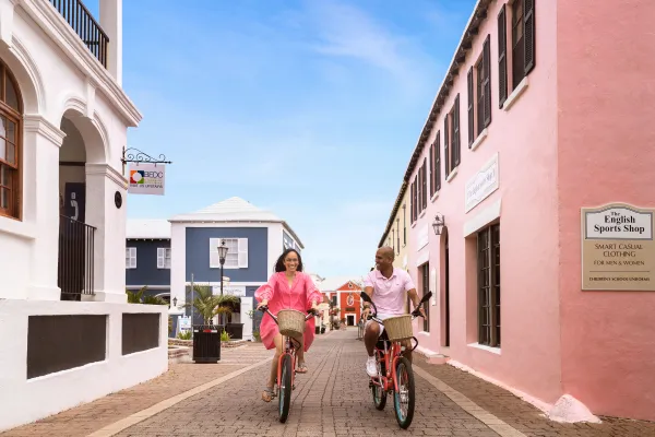 A couple is riding bicycles down St. George's.