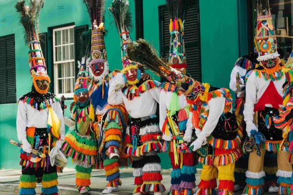A group of colourful Bermuda gombeys are posing for the camera.