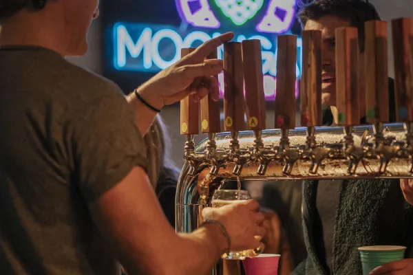 A close up of beer on a tap.