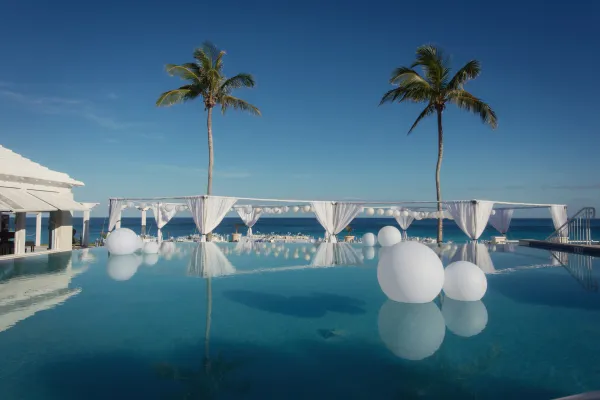 Balloons resting on an infinity pool
