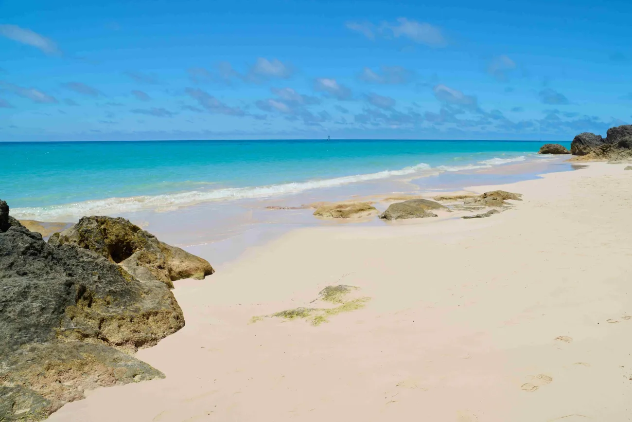 A secluded west whale bay beach with turquoise waters and pink sand.
