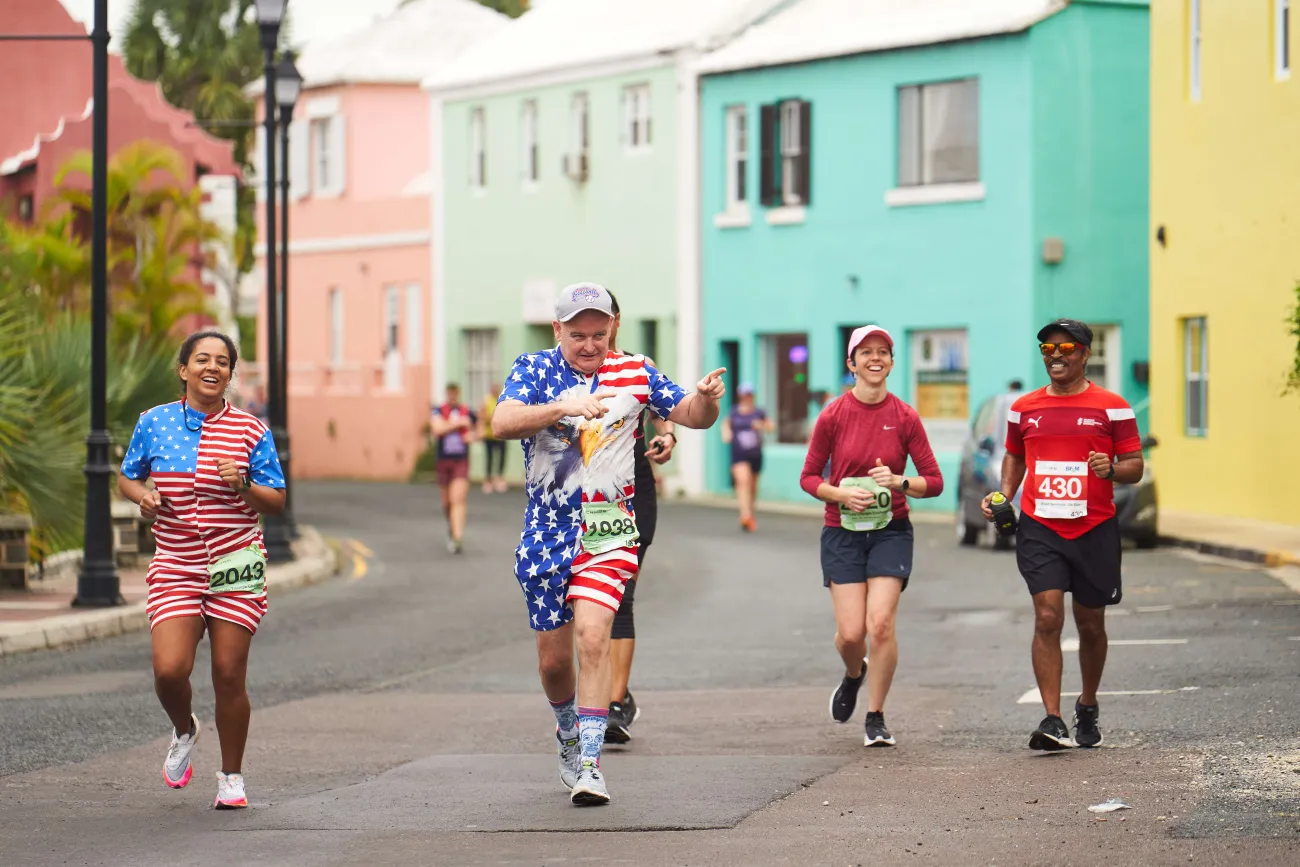 A group of people are running smiling at Flatts Village.