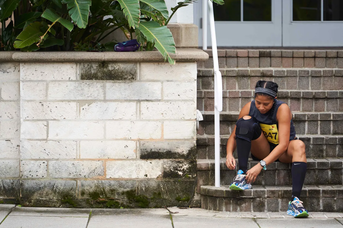 A woman is preparing to go for a run.