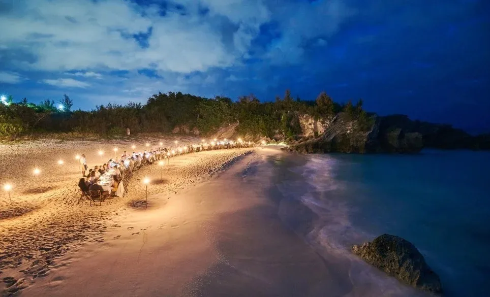 people dining at the beach at night
