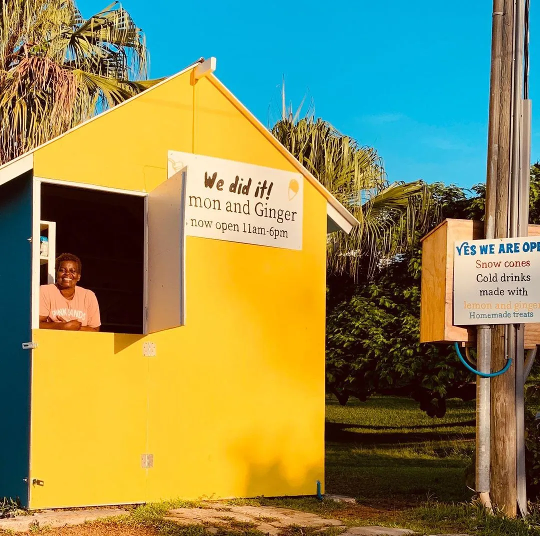 A woman is smiling by her concession stand.