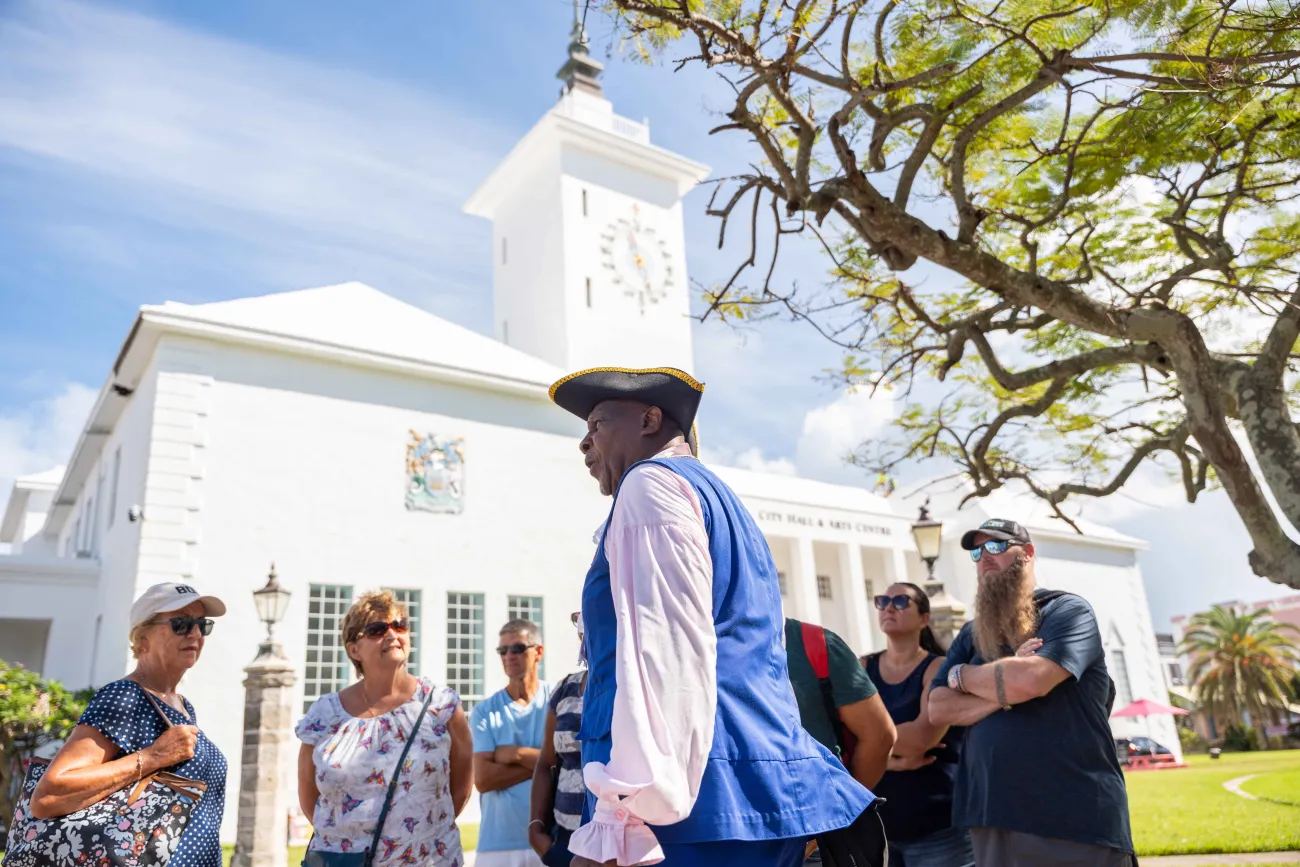 A group of people are standing with the Town Crier 