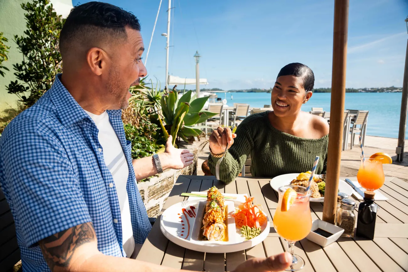 Exterior view of The Wharf with a couple eating lunch.