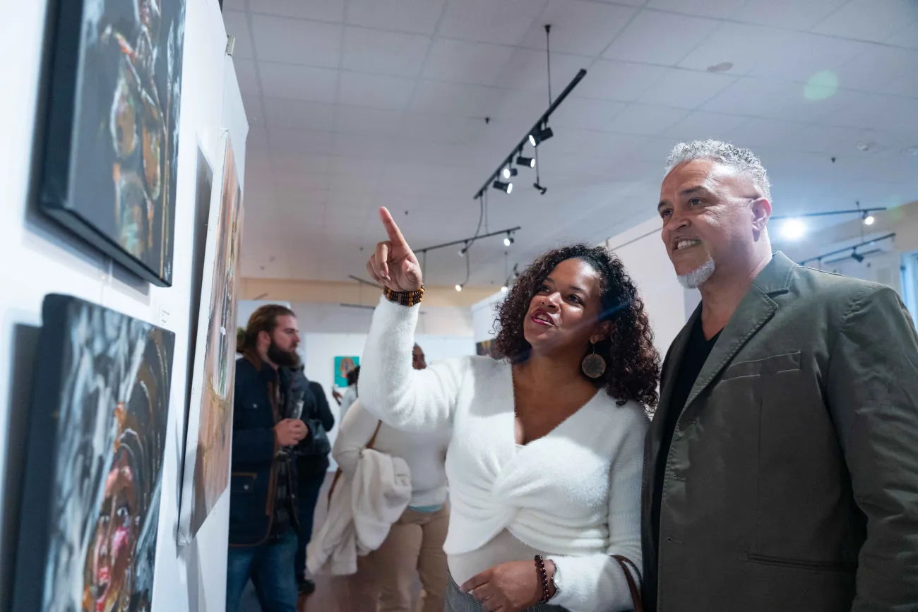 A couple are experiencing an art gallery.