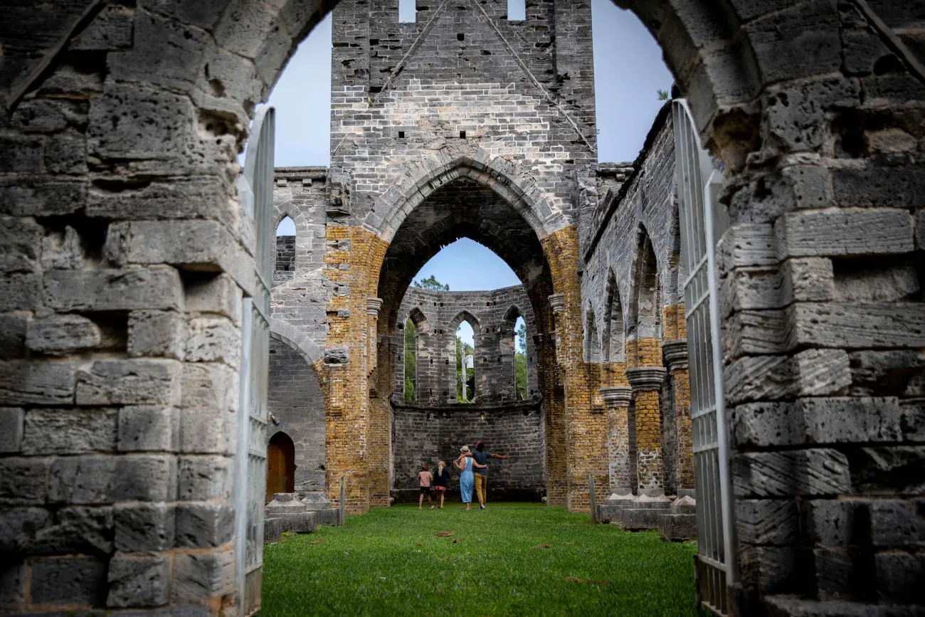 A family is standing in an unfinished church.
