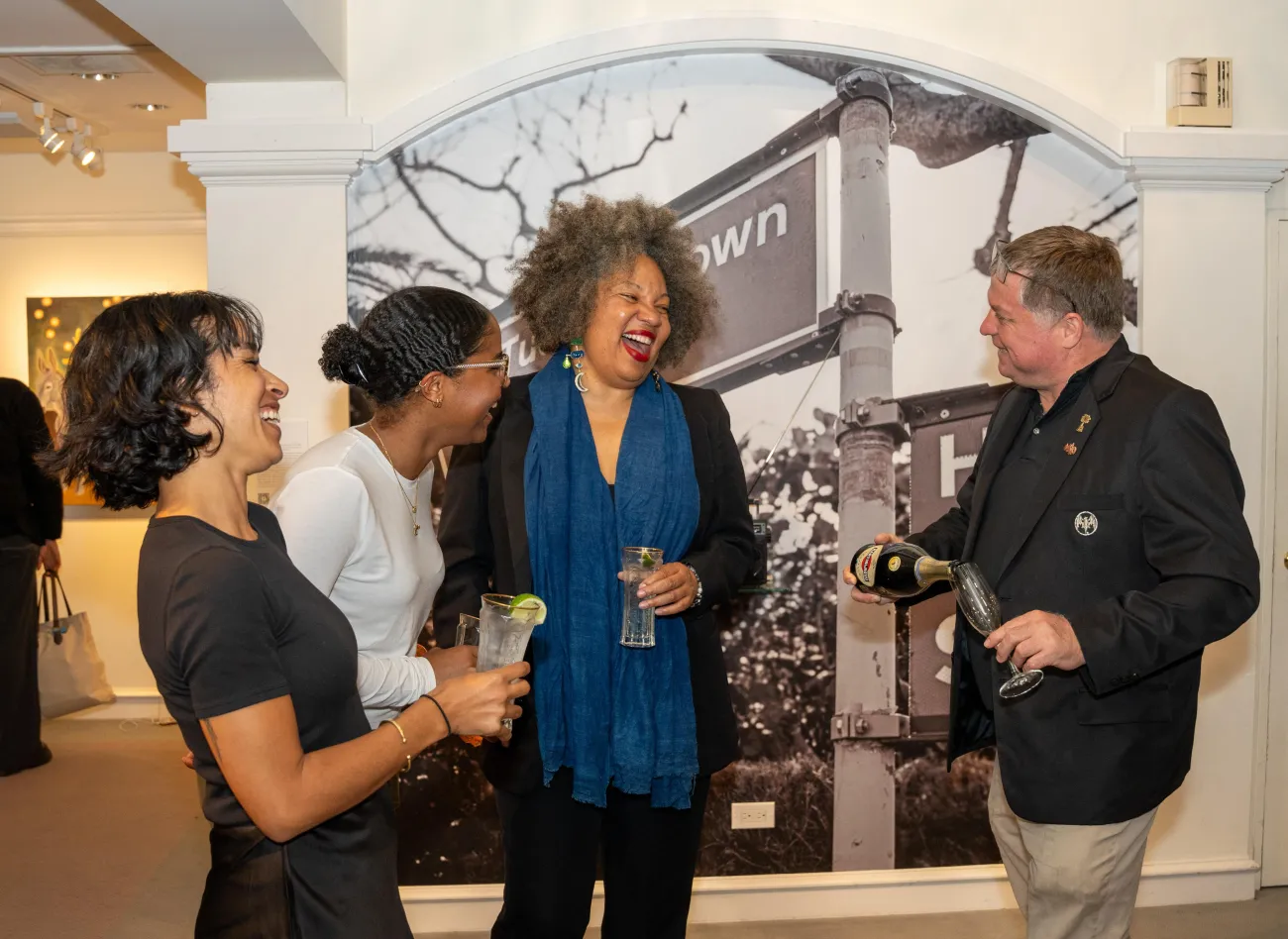 A group of people are smiling talking.