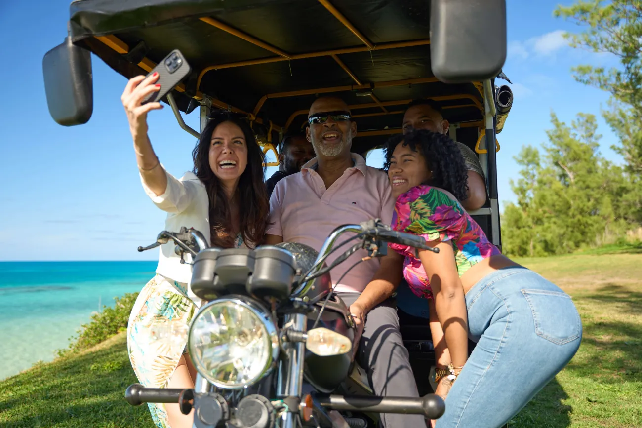 A group are sitting in a tuk tuk tour.