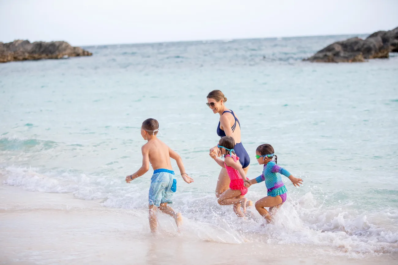 A family running on the beach in Bermuda