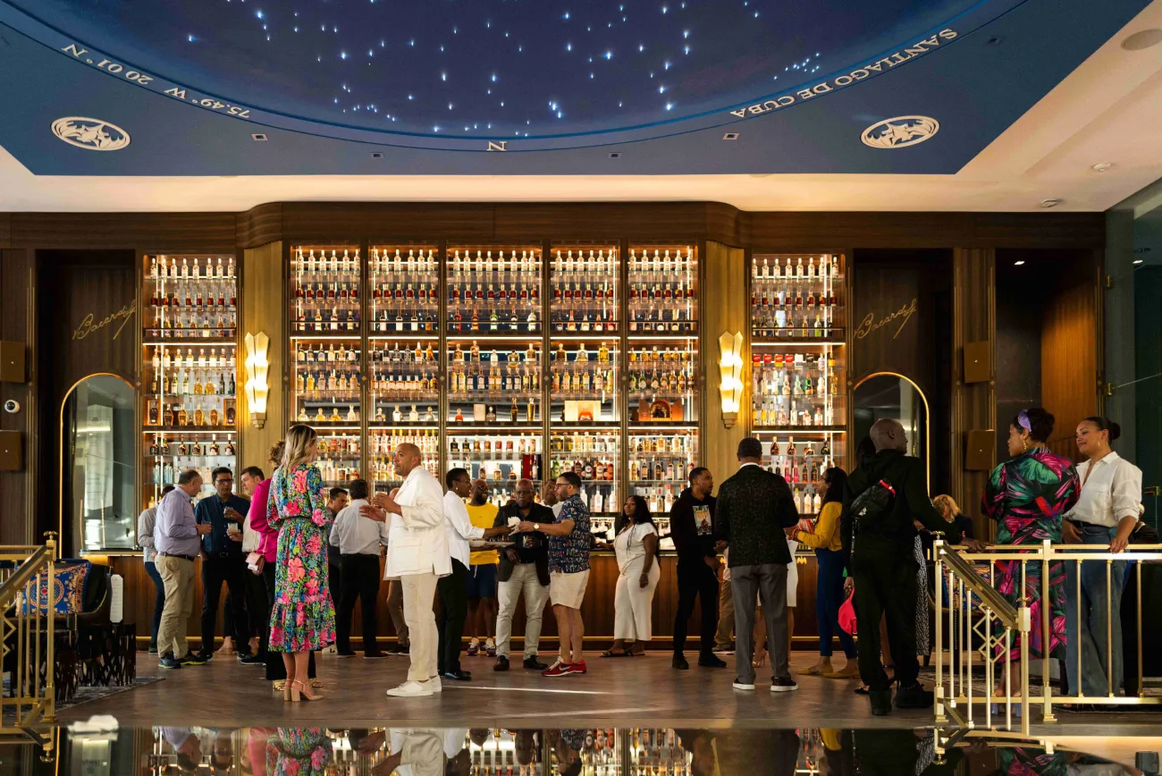 A group of people are standing in the Bacardi Headquarters building.