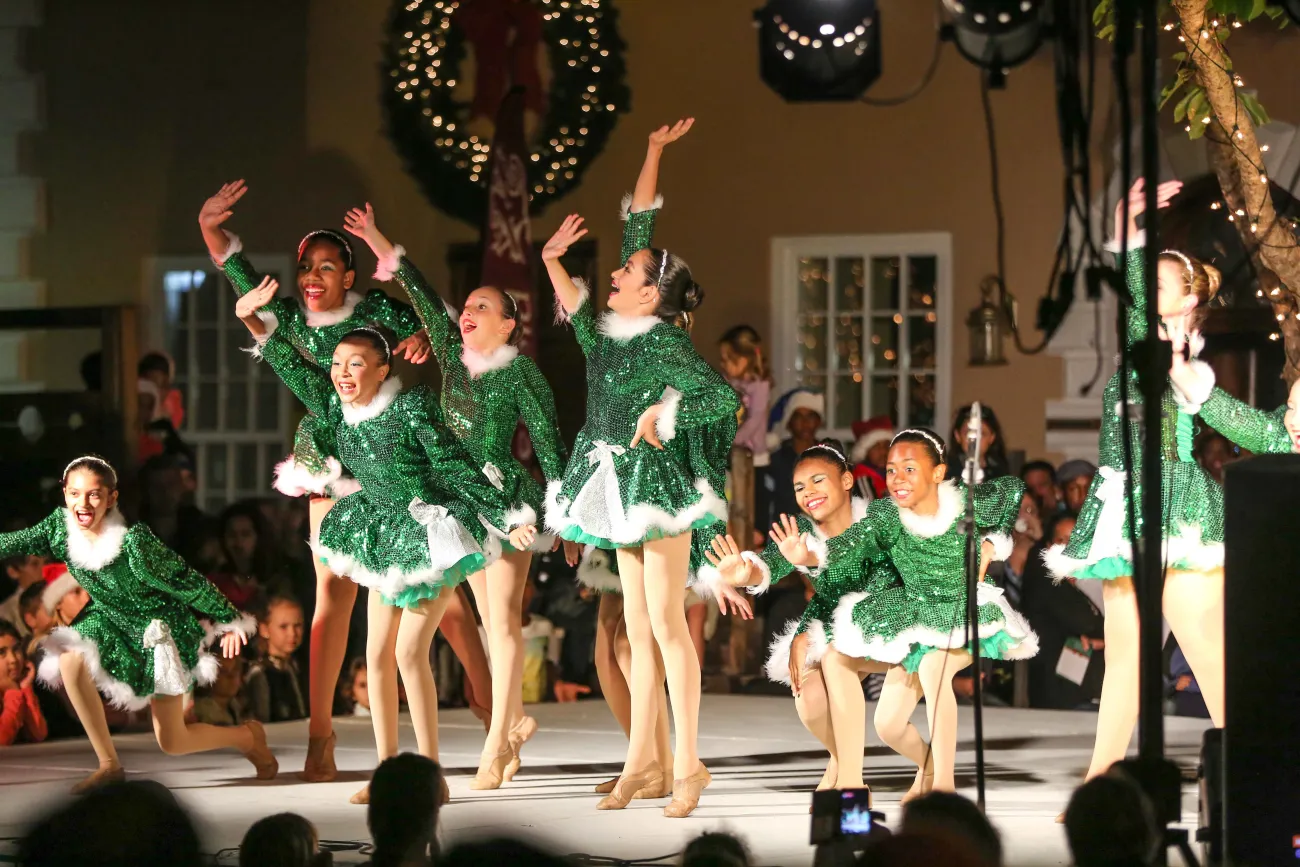 A group of little girls are performing in Elf outfits.