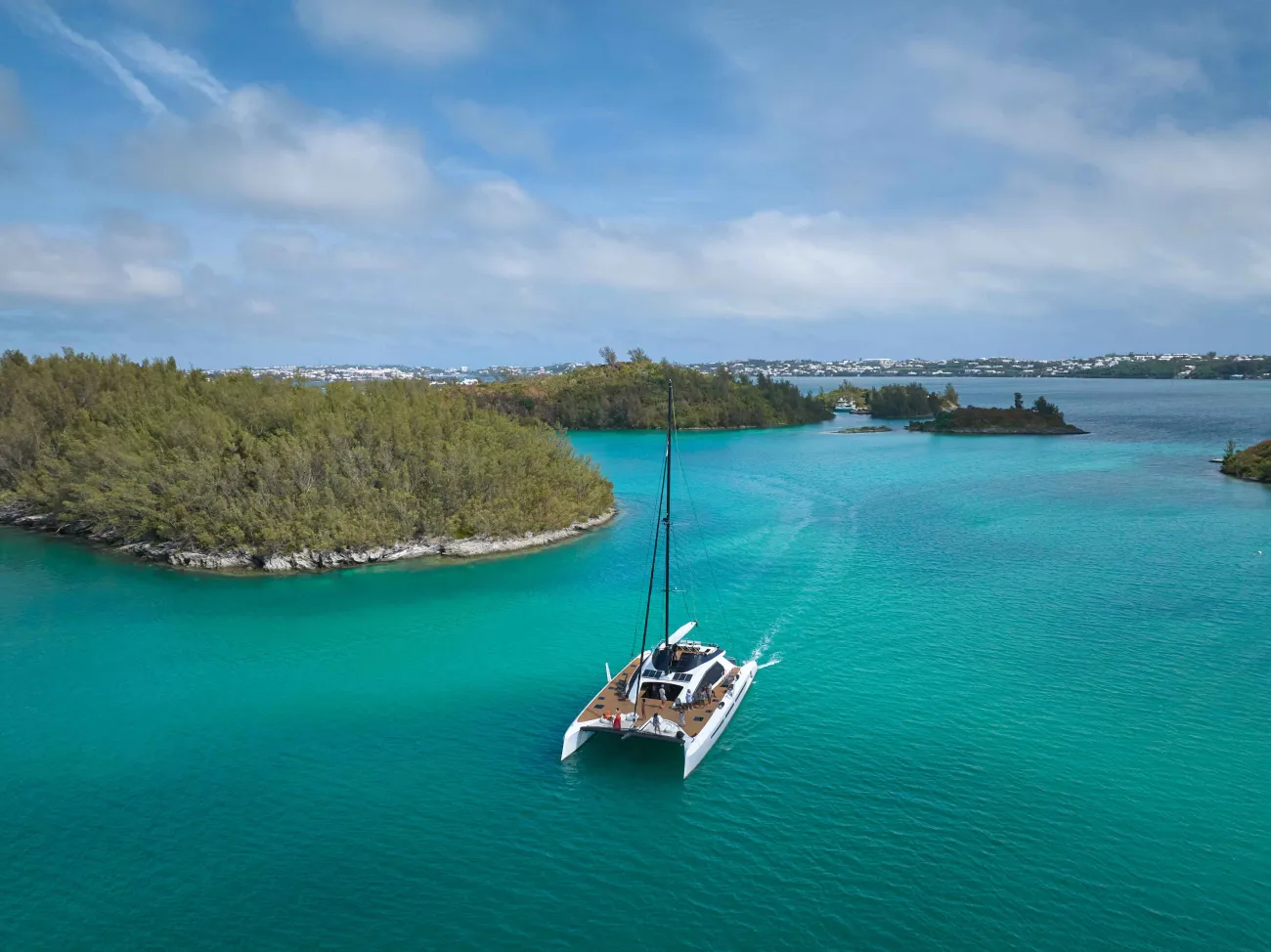 An aerial view of the great sound with a large catamaran in the middle.