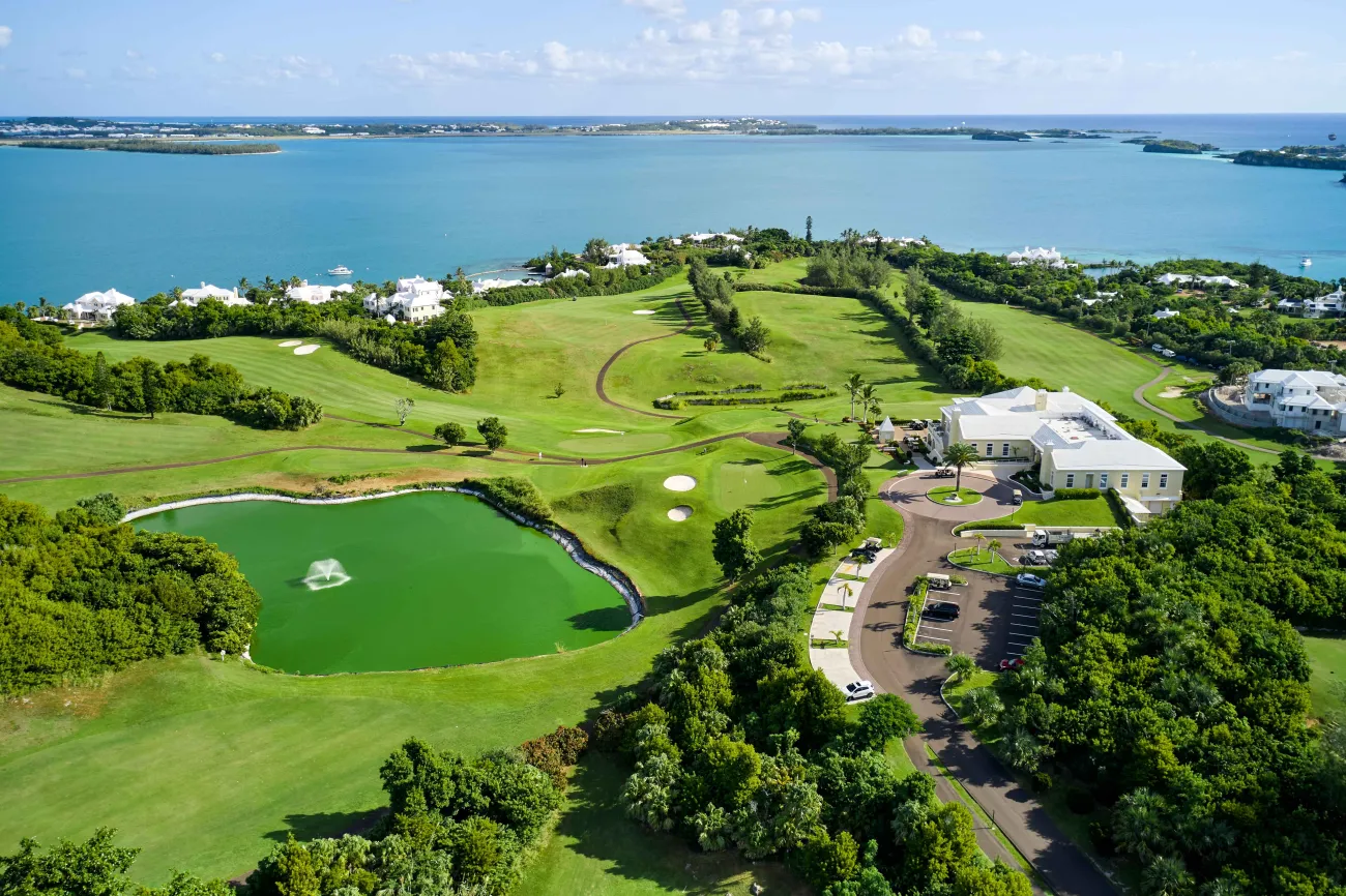 Aerial view of Tucker's Point golf course with a pond and green fairways.