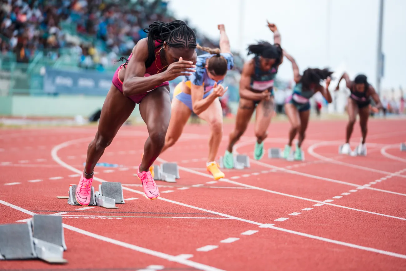 A group of women are running on a track.