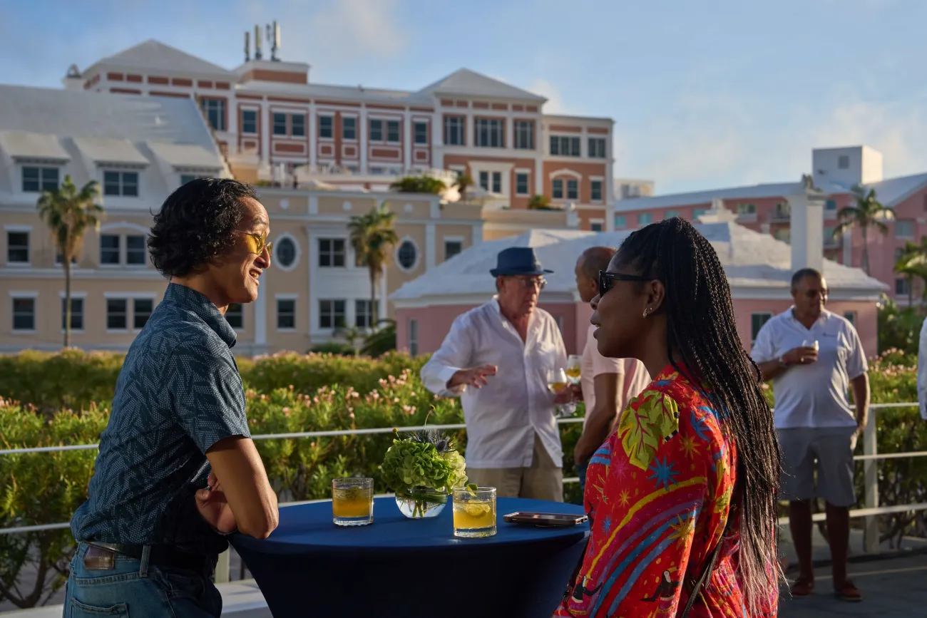 Two people are talking to each other with a scenic background.