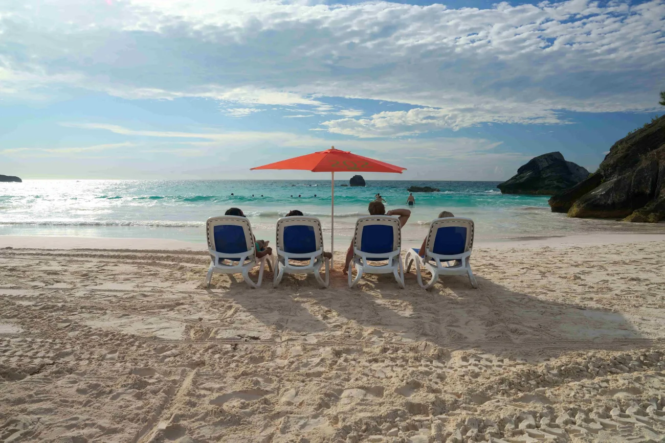 A group of friends are sitting on beach chairs at Horseshoe Bay