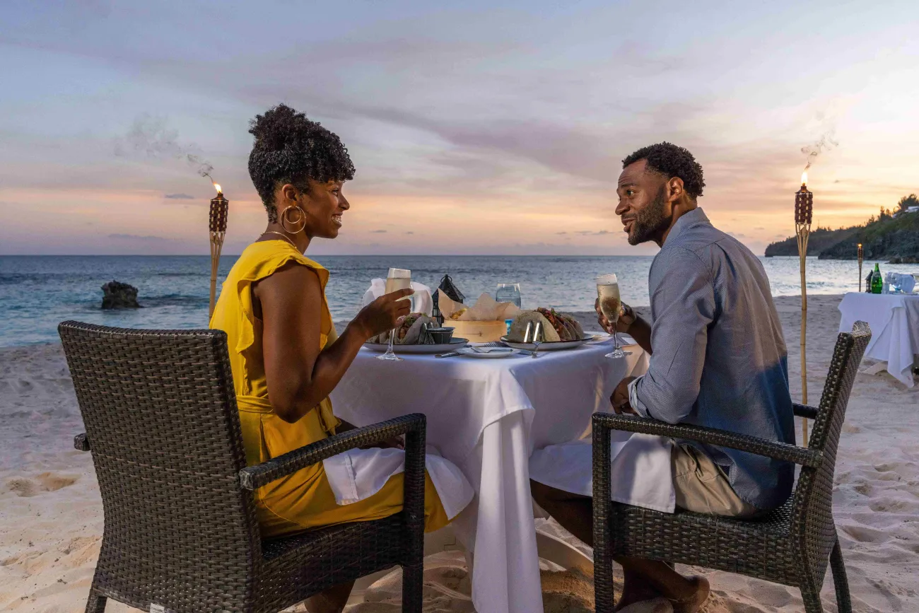 A couple is sitting on the beach.
