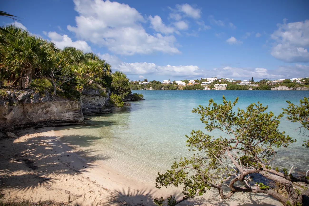 Crystal clear waters with colourful houses in the background.