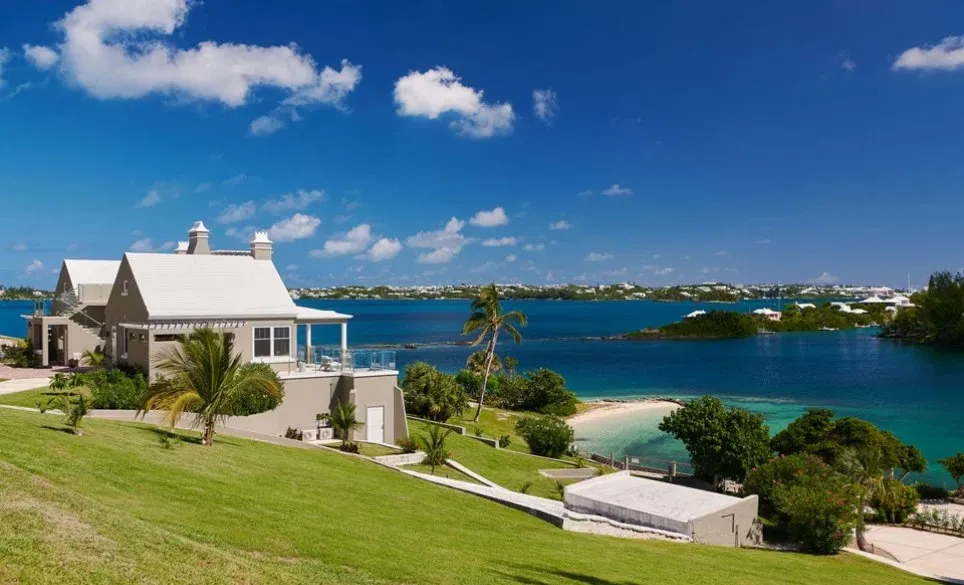 A building on a hill overlooking the water