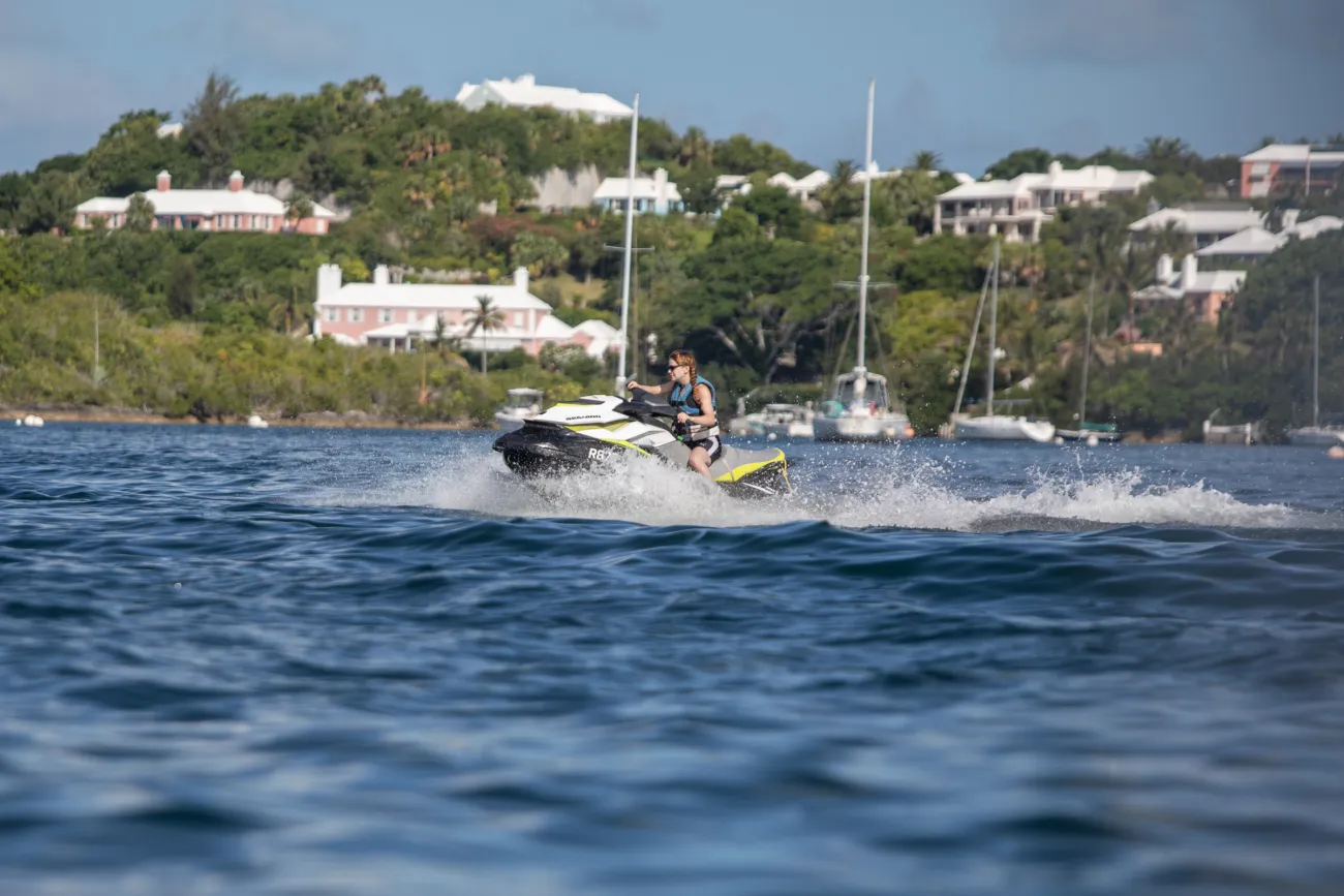 A woman is riding a jetski.