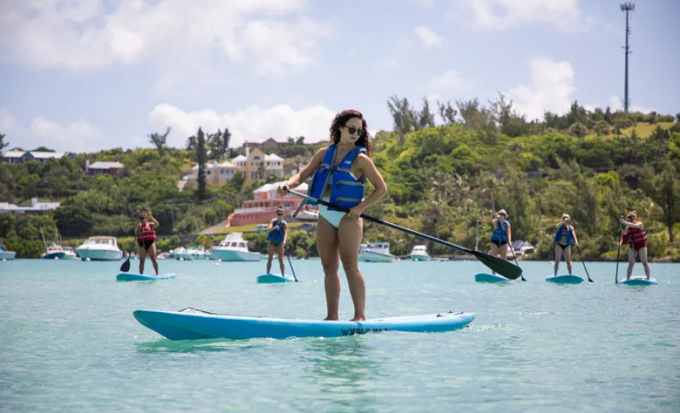 A group of people on stand up paddle boards