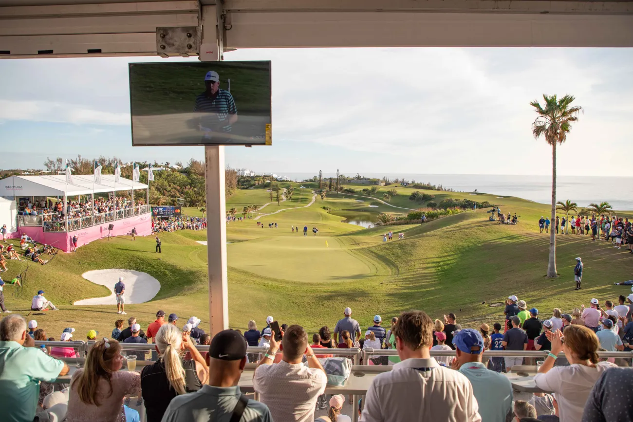 People watching the Butterfield Golf Championship on a calm day.