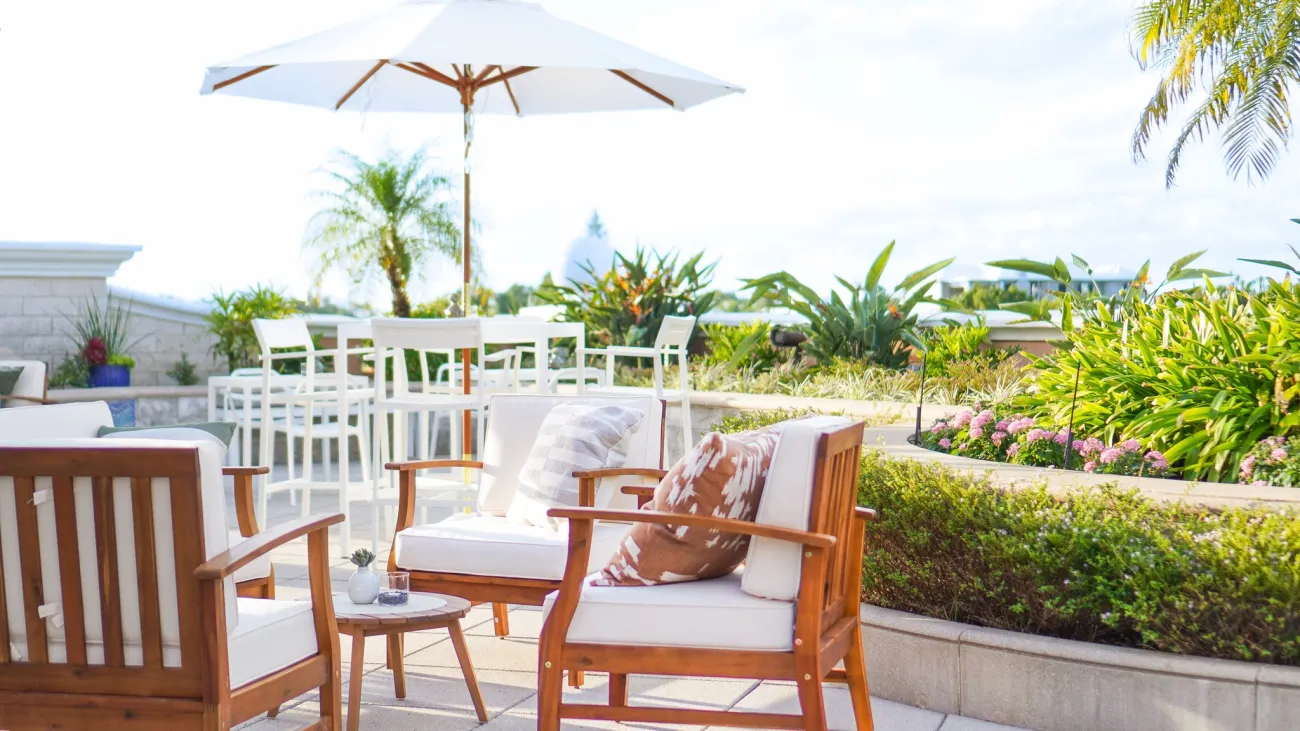 Eye level view of The Cloud Restaurant with chairs and greenery. 